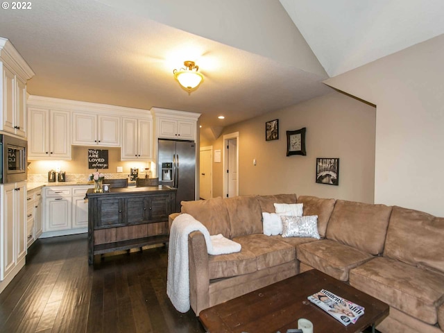 living room featuring vaulted ceiling and dark wood-type flooring