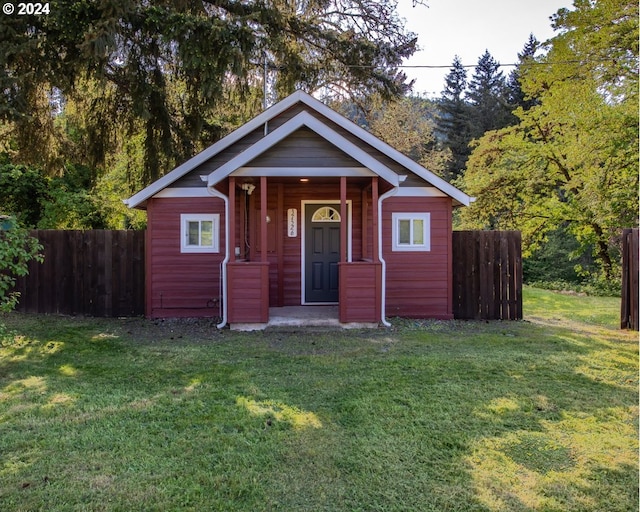 bungalow-style home featuring a front yard