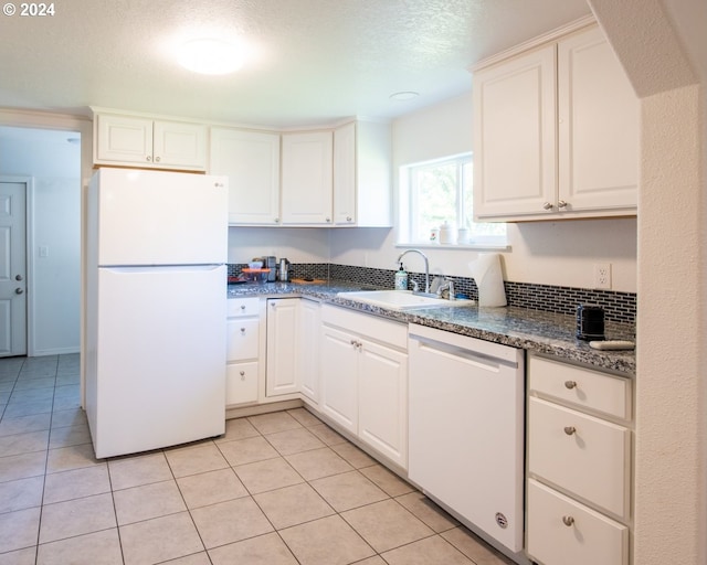 kitchen featuring a textured ceiling, white cabinetry, sink, and white appliances