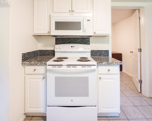 kitchen with white cabinets, white appliances, and dark stone counters