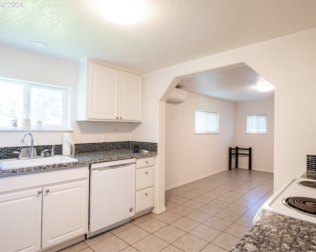 kitchen featuring dishwasher, white cabinetry, sink, and a wall mounted AC