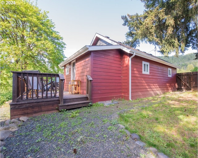 view of property exterior with a deck