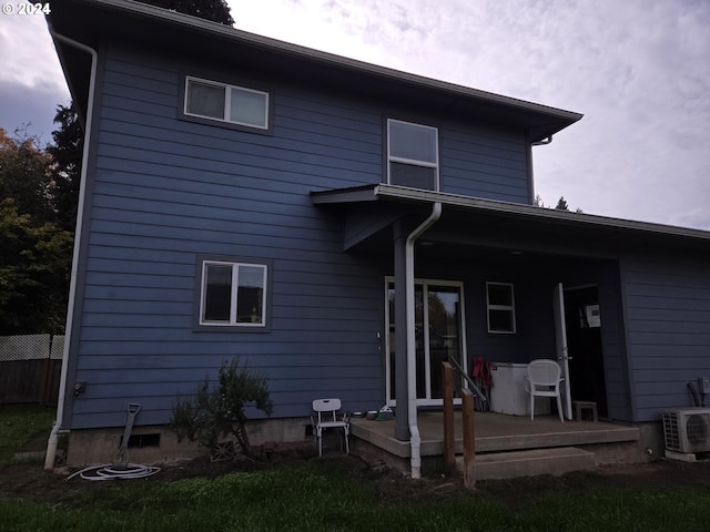 rear view of property featuring ac unit