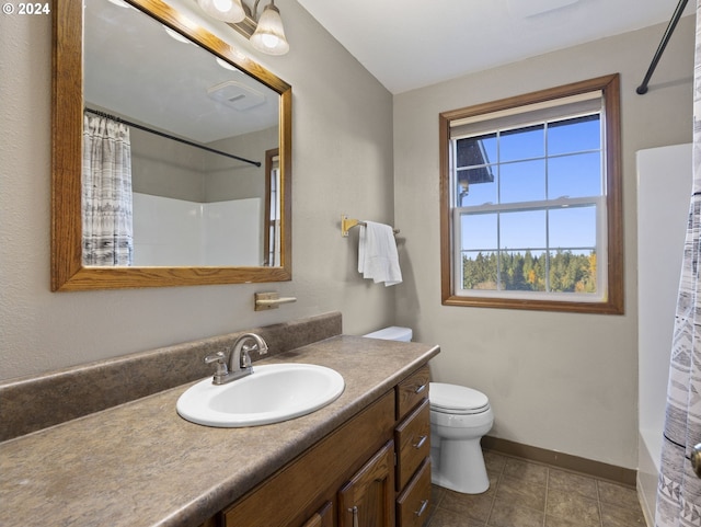 bathroom featuring tile patterned floors, vanity, and toilet