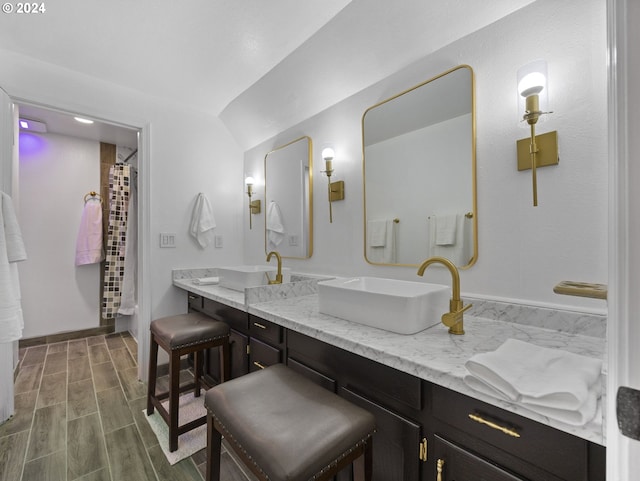 bathroom featuring wood-type flooring, vanity, and curtained shower