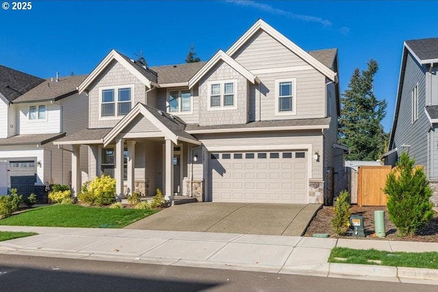 craftsman-style home featuring a garage, covered porch, and a front lawn