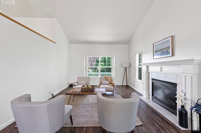1157 Yew St, Junction City, OR 97448 - living area featuring a tiled fireplace, wood finished floors, baseboards, and vaulted ceiling