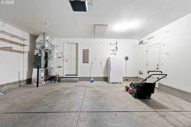 1157 Yew St, Junction City, OR 97448 - garage featuring freestanding refrigerator, water heater, electric panel, and a garage door opener