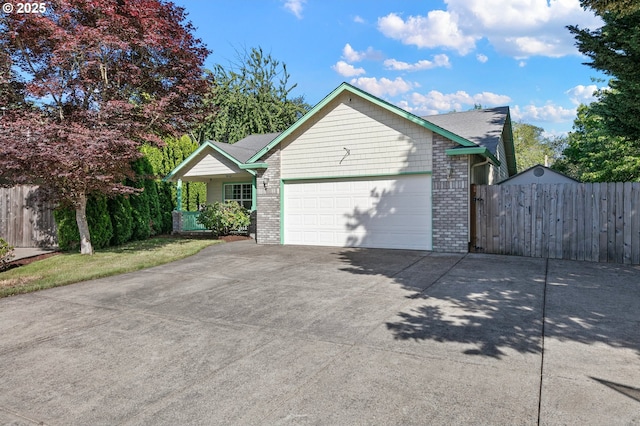 1157 Yew St, Junction City, OR 97448 - view of front facade featuring a garage, concrete driveway, and brick siding