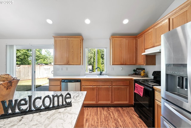 1157 Yew St, Junction City, OR 97448 - kitchen with appliances with stainless steel finishes, a sink, under cabinet range hood, recessed lighting, and light wood-style floors