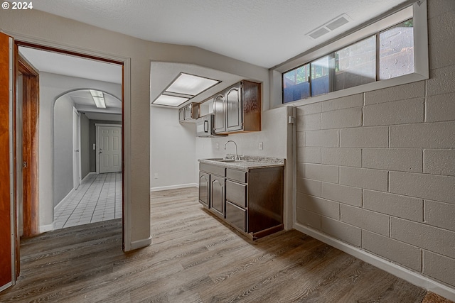 bathroom featuring hardwood / wood-style floors, vanity, and a textured ceiling