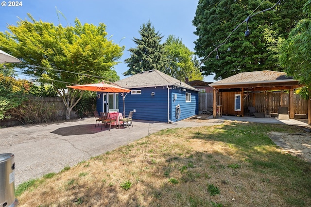 rear view of house with a yard, a patio area, and a gazebo