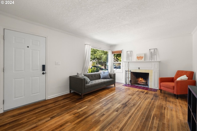 living room featuring a textured ceiling, a tiled fireplace, and dark hardwood / wood-style floors