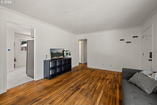 living room featuring crown molding, a textured ceiling, and dark hardwood / wood-style flooring