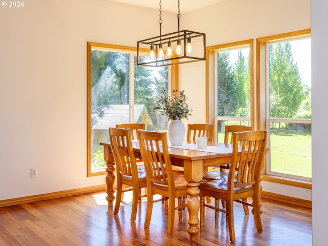 2201 NW Carty Rd, Ridgefield, WA 98642 - dining space featuring wood finished floors, baseboards, and a chandelier