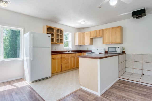 2201 NW Carty Rd, Ridgefield, WA 98642 - kitchen featuring white appliances, dark countertops, a sink, and light wood-style floors