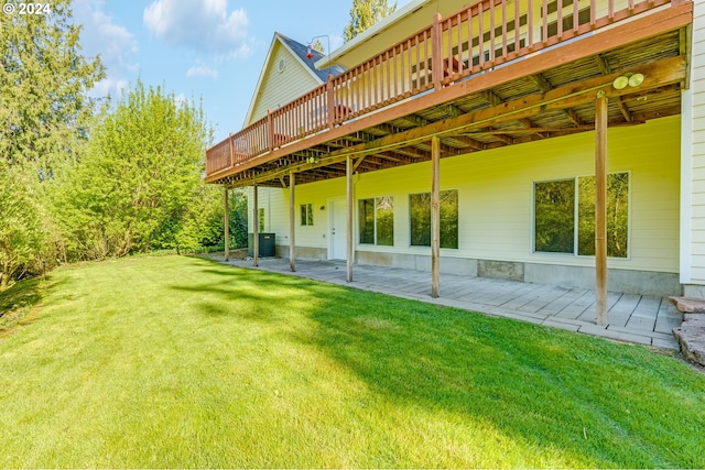 back of house with a patio area, a deck, a lawn, and central AC