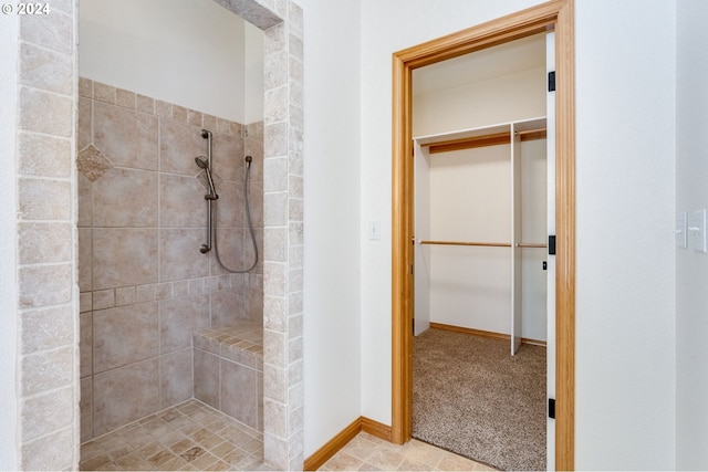 2201 NW Carty Rd, Ridgefield, WA 98642 - bathroom featuring a tile shower, baseboards, and a spacious closet