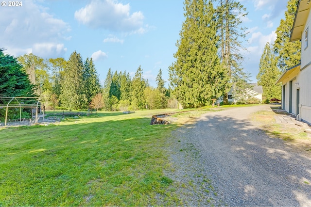 2201 NW Carty Rd, Ridgefield, WA 98642 - view of grassy yard with driveway and a garage