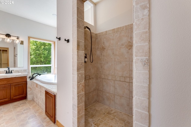 bathroom featuring vanity and shower with separate bathtub