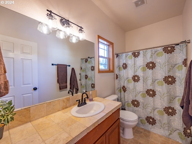 bathroom featuring toilet, tile patterned floors, and vanity