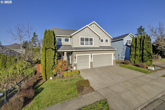 traditional-style house with an attached garage, fence, driveway, and a shingled roof