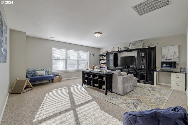 living room with visible vents, light colored carpet, and baseboards