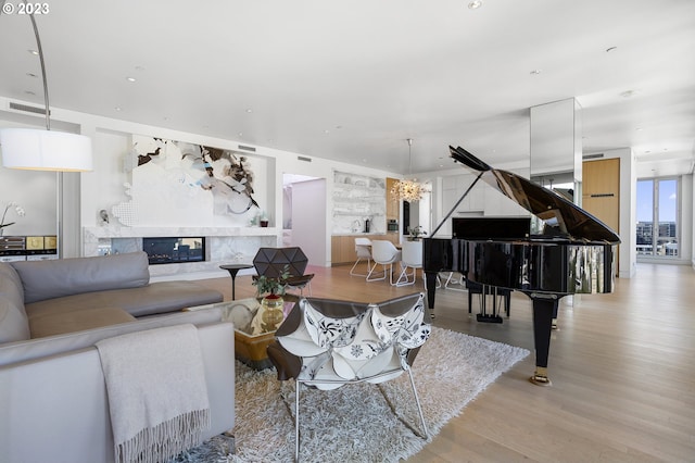 living room featuring light hardwood / wood-style flooring and a high end fireplace