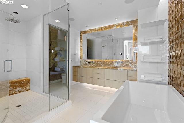 full bathroom featuring vanity, plus walk in shower, and tile walls