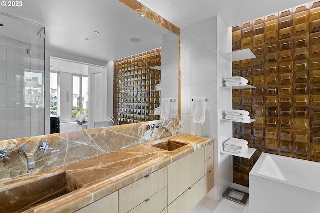 bathroom with sink, tile walls, and tile patterned floors