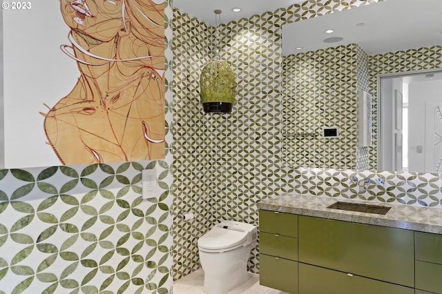 bathroom featuring vanity, toilet, and tile patterned flooring