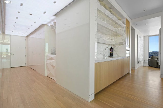 hall featuring sink and light hardwood / wood-style floors