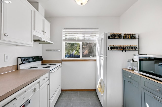 kitchen with light countertops, white appliances, baseboards, under cabinet range hood, and white cabinetry