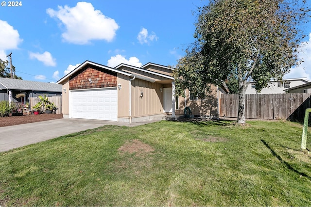 ranch-style home featuring driveway, a garage, fence, and a front yard