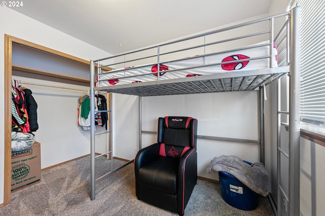 bedroom with baseboards, a closet, and carpet flooring