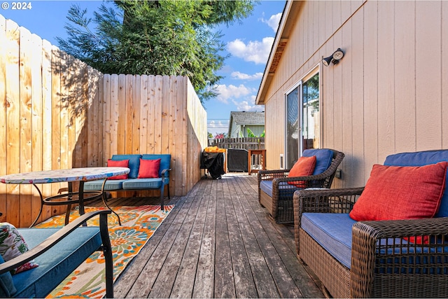 wooden terrace featuring fence