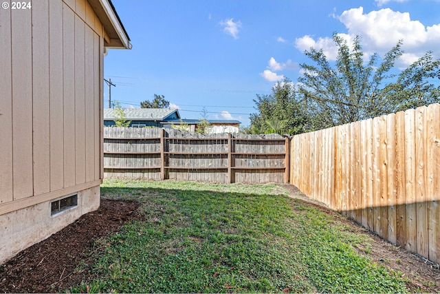 view of yard with a fenced backyard