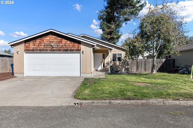 view of front of property featuring a front yard, an attached garage, fence, and concrete driveway