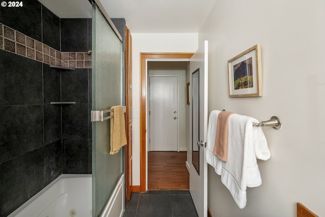 821 SE 29th Ave Unit 1, Portland, OR 97214 - bathroom with tile patterned floors, a combined bath / shower with jetted tub, and baseboards