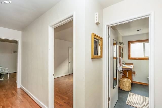 hall with hardwood / wood-style floors