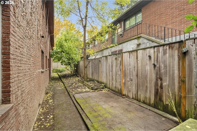 821 SE 29th Ave Unit 1, Portland, OR 97214 - view of property exterior featuring brick siding, fence, and a patio area