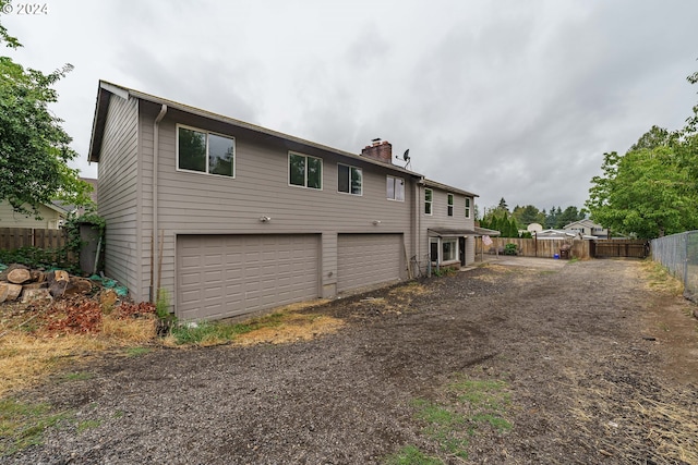 rear view of house with a garage