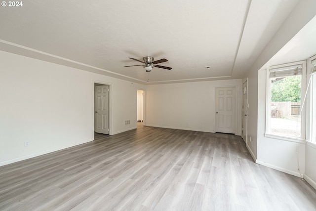 spare room with ceiling fan and light wood-type flooring