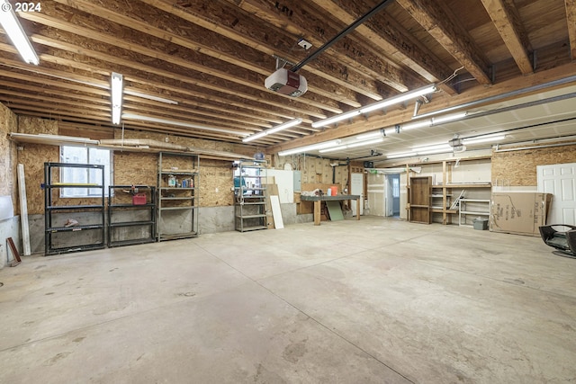 garage featuring a garage door opener and a workshop area