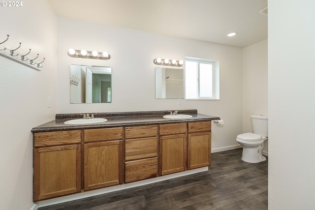 bathroom featuring vanity, hardwood / wood-style flooring, and toilet