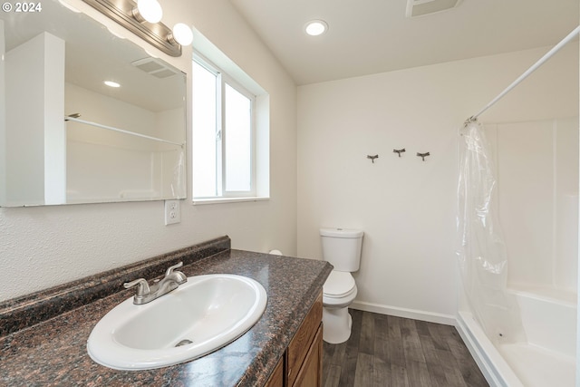 bathroom with a shower with curtain, vanity, toilet, and hardwood / wood-style floors