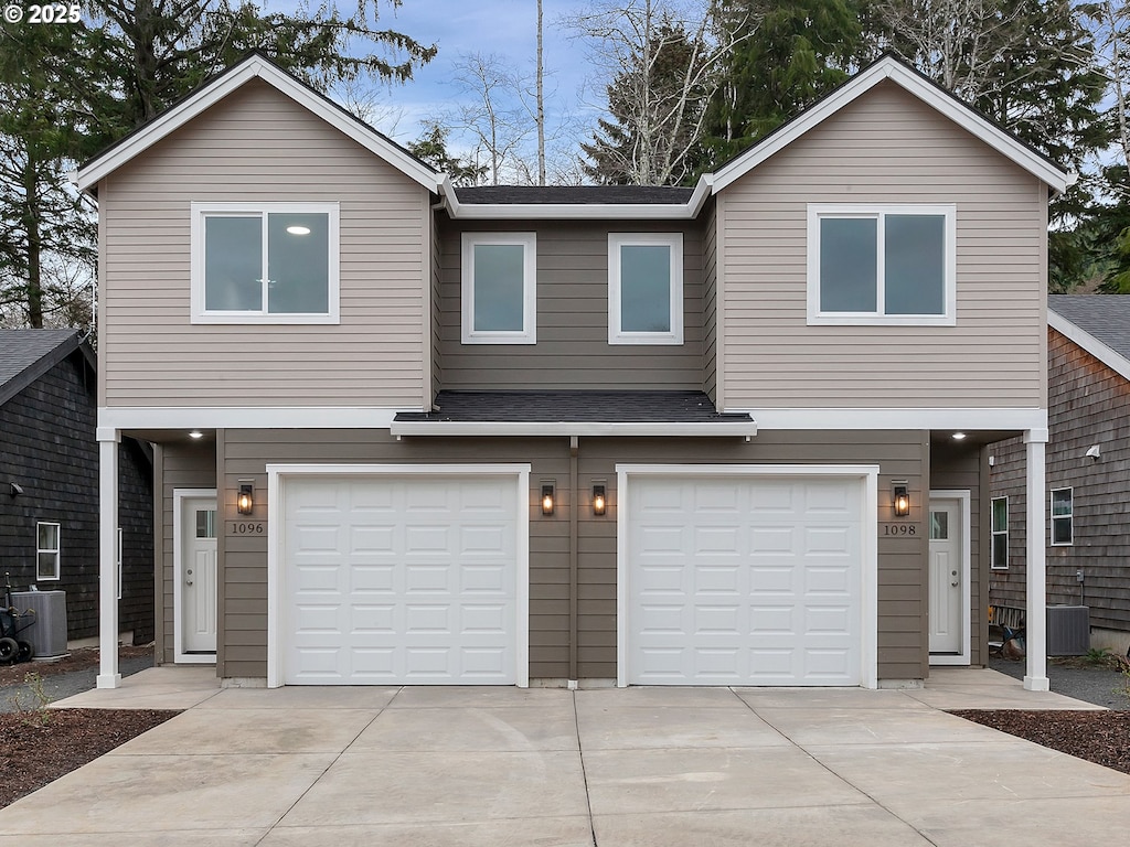 view of front of property with central AC and a garage