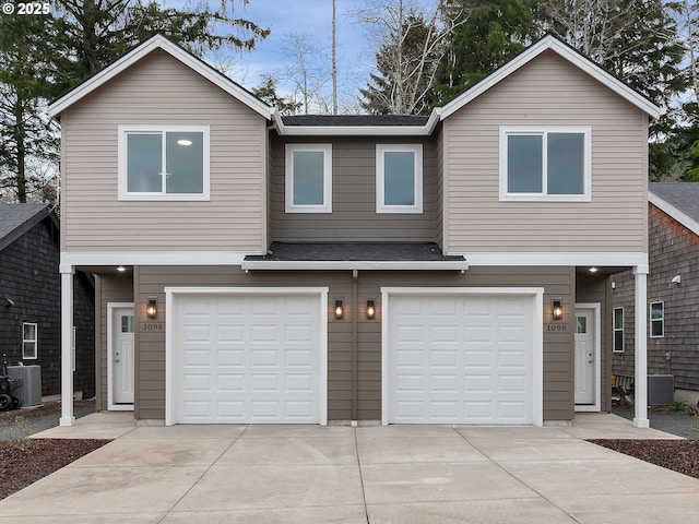 view of front of property with central AC and a garage