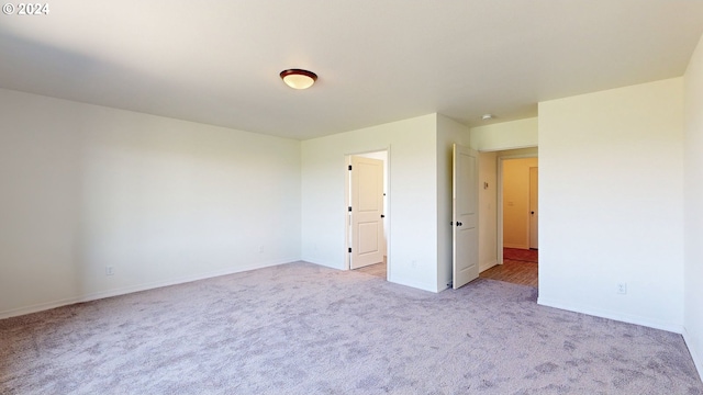 unfurnished bedroom with light colored carpet