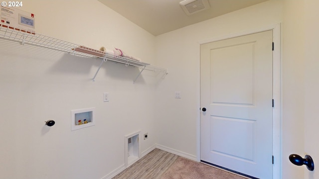 laundry room featuring hookup for an electric dryer, hookup for a washing machine, and light wood-type flooring